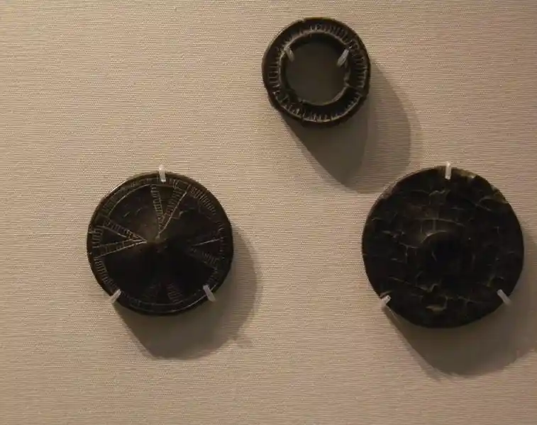Prechristian cross on jet buttons and rings
